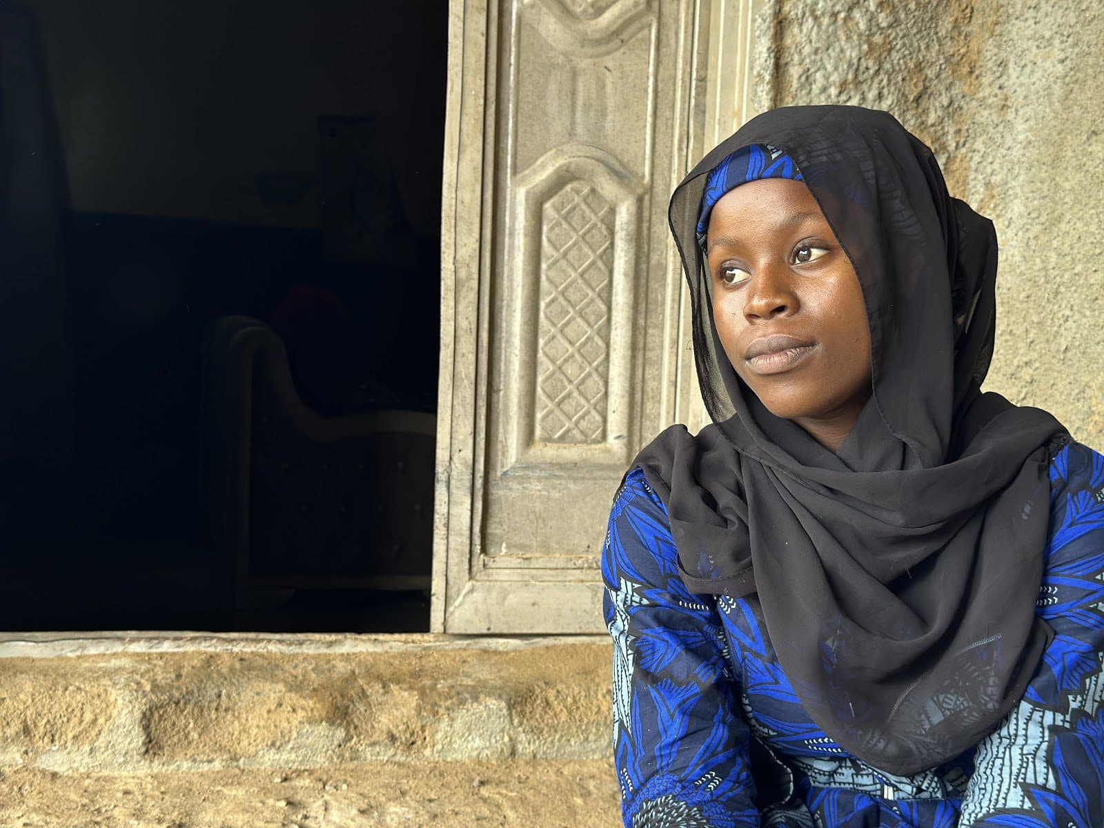 Na’empere Daniel looks to her side at a location in Yauri, North West Nigeria. Photo: Hauwa Shaffii Nuhu/HumAngle.