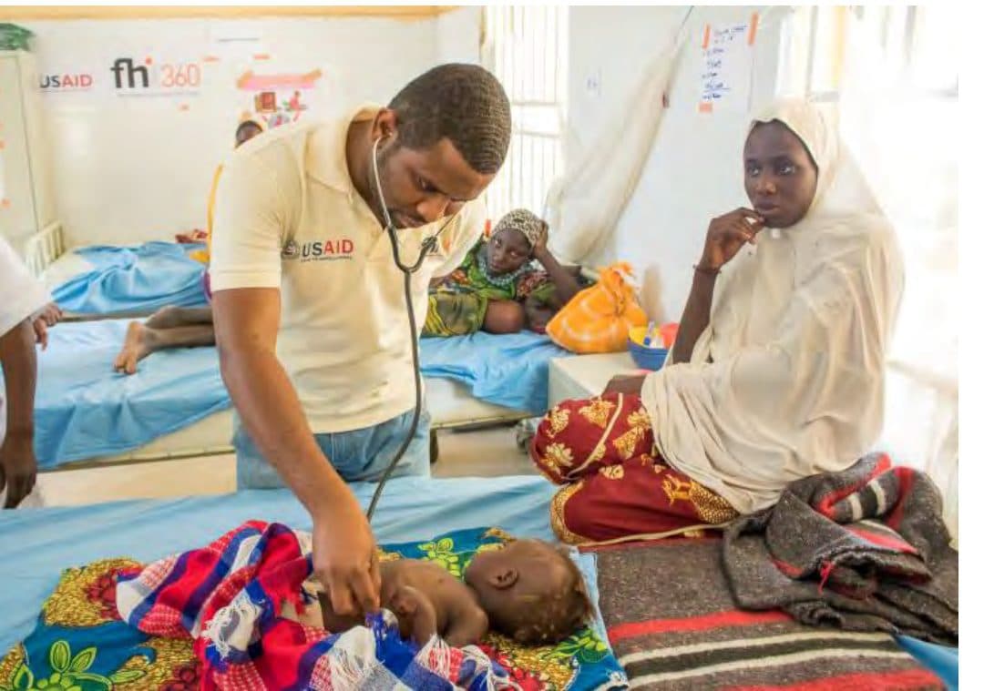 File: A doctor examining an SCW patient at an FHI360 facility.