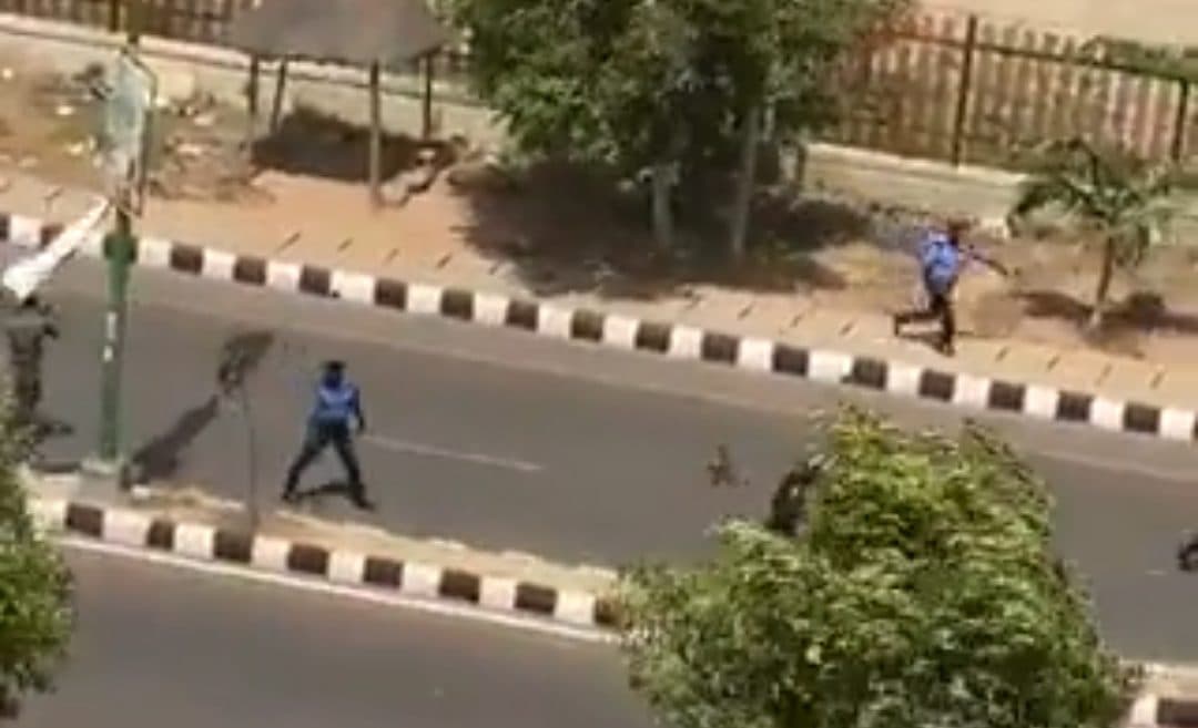 A screenshot from the video shows the police retreating after the clash.