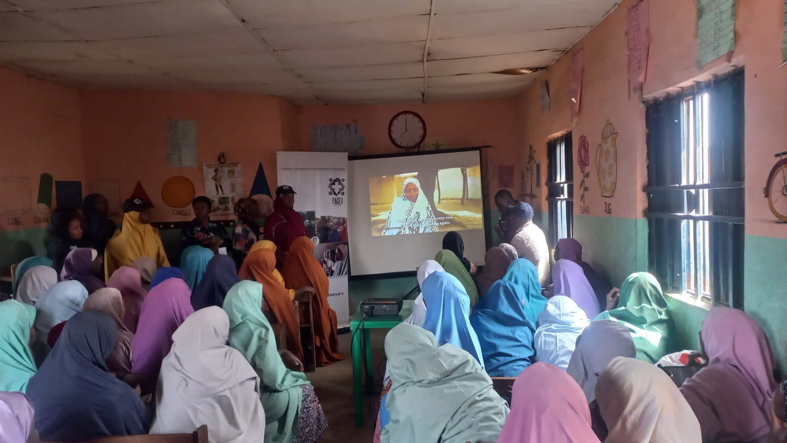 Over 50 women in Malali village gather to watch a six-minute documentary during PAGED Initiative’s advocacy campaign to break down barriers against girls’ education in Kaduna on Dec. 13. Photo: Nathaniel Bivan/HumAngle