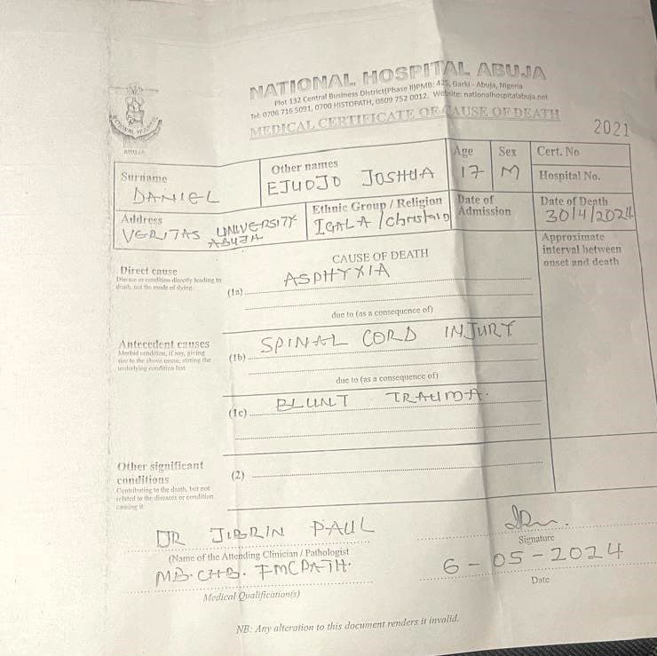 A blurred image of a medical certificate indicating the cause of death with handwritten notes and a signature.