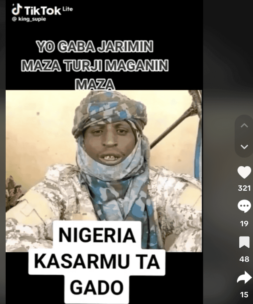 A person in camouflage attire on a TikTok video with overlaid text in a different language.
