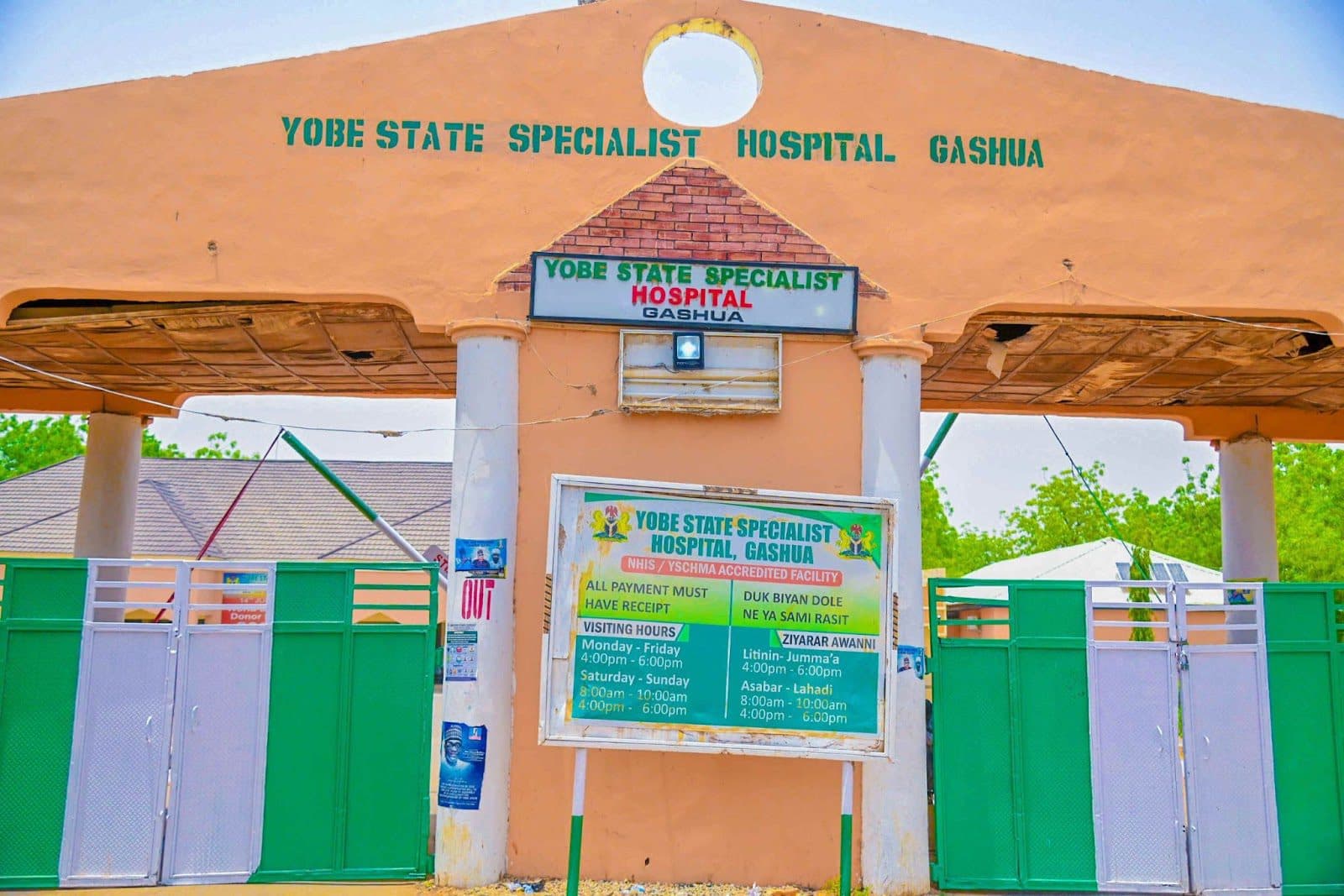 Entrance gate and signboard of Yobe State Specialist Hospital, Gashua, under a sunny sky.