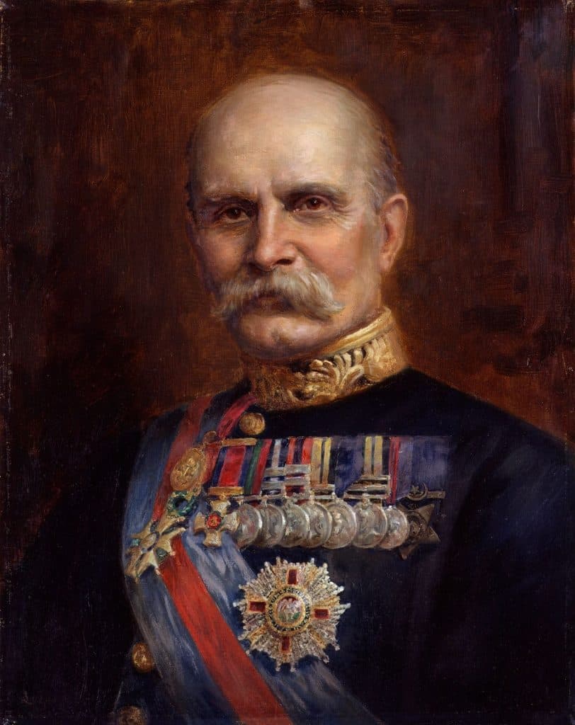 Portrait of a man in a military uniform adorned with numerous medals and decorations, set against a dark, textured background.