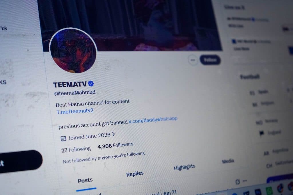 Close-up of a social media profile named TEEMATV with a blue verification check. Bio includes a link and reference to a banned account.