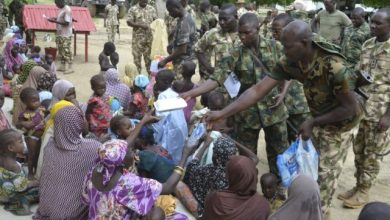 Military giving water to civilians in Borno State