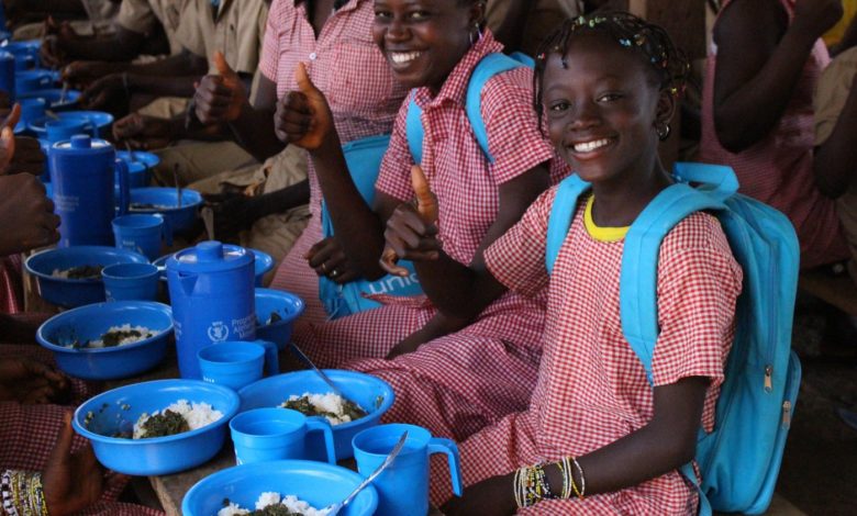 Children eating rice with vegetables