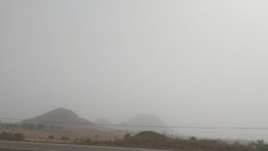 Dust haze covers the mountains along Abuja Airport Road.