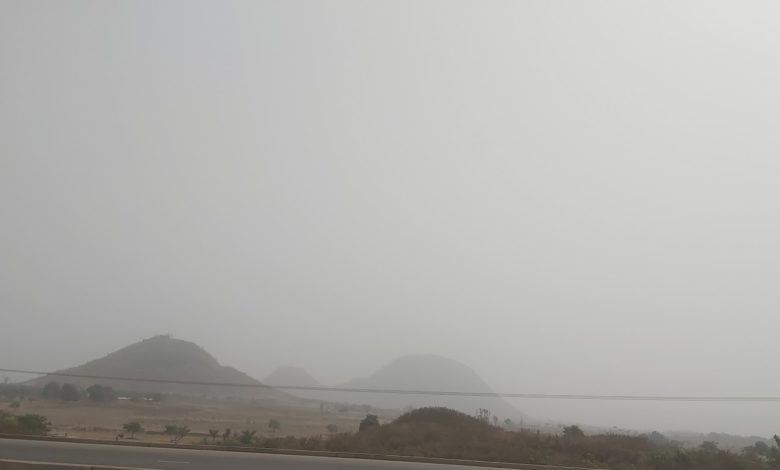 Dust haze covers the mountains along Abuja Airport Road.