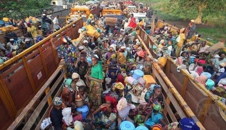 A picture of trucks containing people forced from their homes by flooding