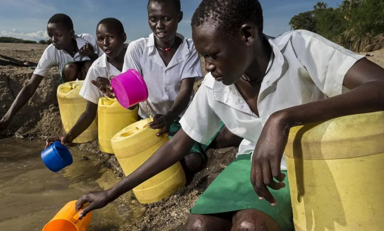 School girls fetch water from a dry riverbed in Lake Turkana is too saline for human consumption.