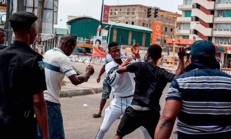 A fight breaks out over the alleged distribution of money for votes at a polling unit in Alagomeji-Yaba in Lagos on Feb. 23, 2019, during the general elections