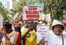 Protestors holding signs against femicide, advocating to stop violence against women. #EndFemicideKE
