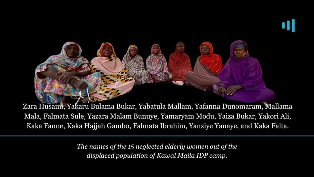 Group of 15 elderly women sitting against a black background, representing a displaced population.