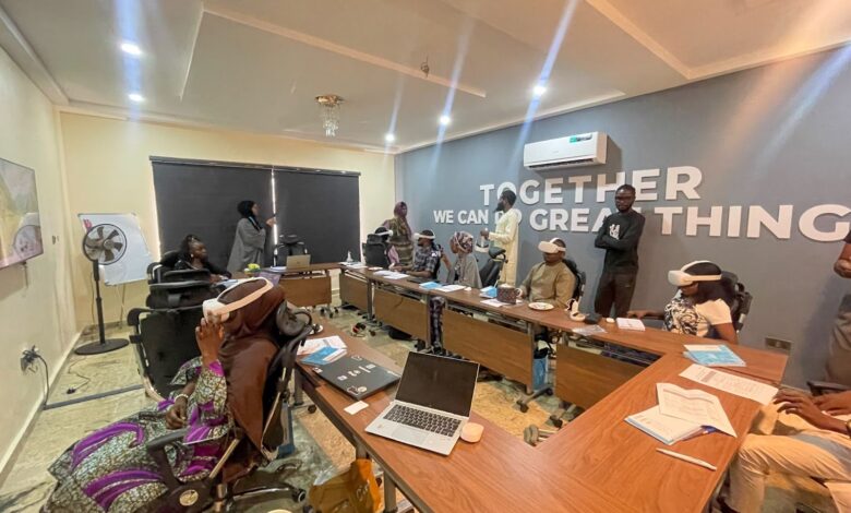 Group of people engaged in a meeting or training session in an office with the slogan "Together we can do great things" on the wall.