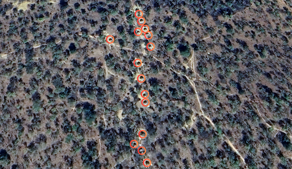 Aerial view of a landscape with red circles marking specific locations.