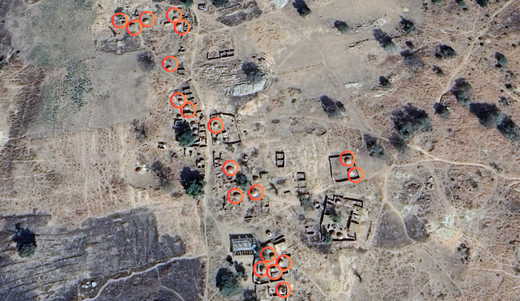 Aerial view of a deserted area with buildings and several circled points of interest.