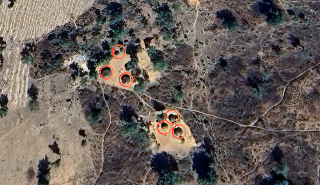 Aerial view of a landscape with several areas circled in red.