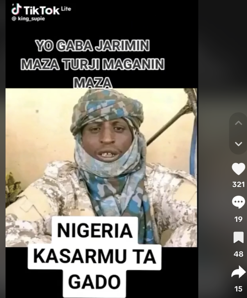 A person in camouflage attire on a TikTok video with overlaid text in a different language.