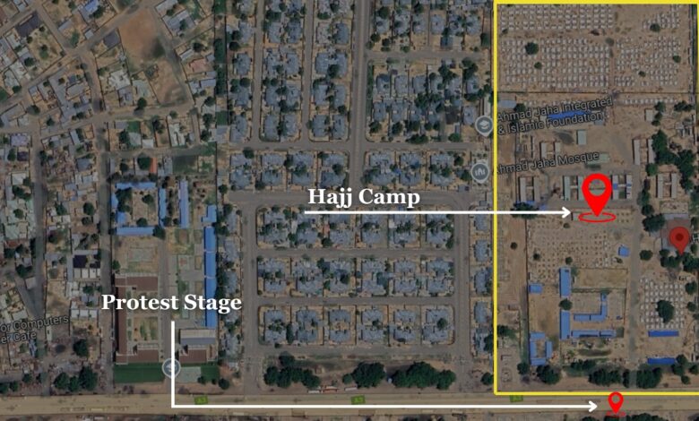 Satellite view of an urban area with labeled locations: Hajj Camp, Protest Stage, and a mosque.