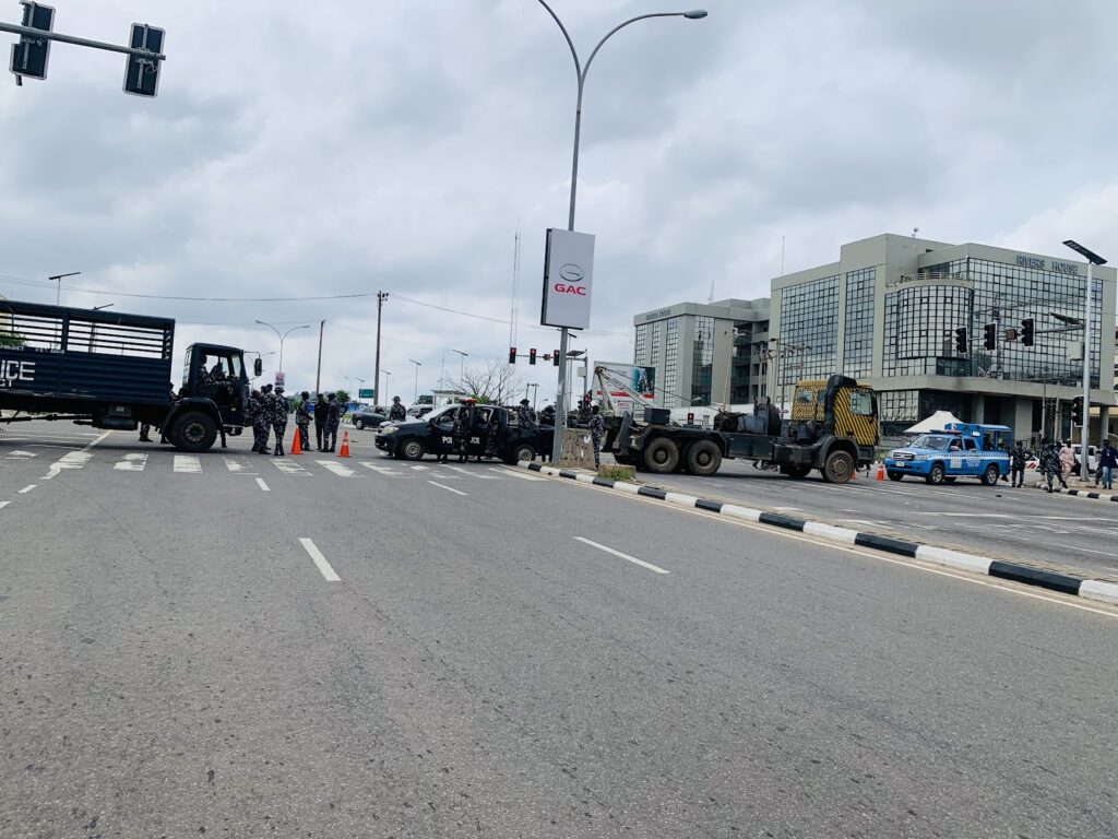 Urban street scene with police and vehicles, possibly during a security operation.