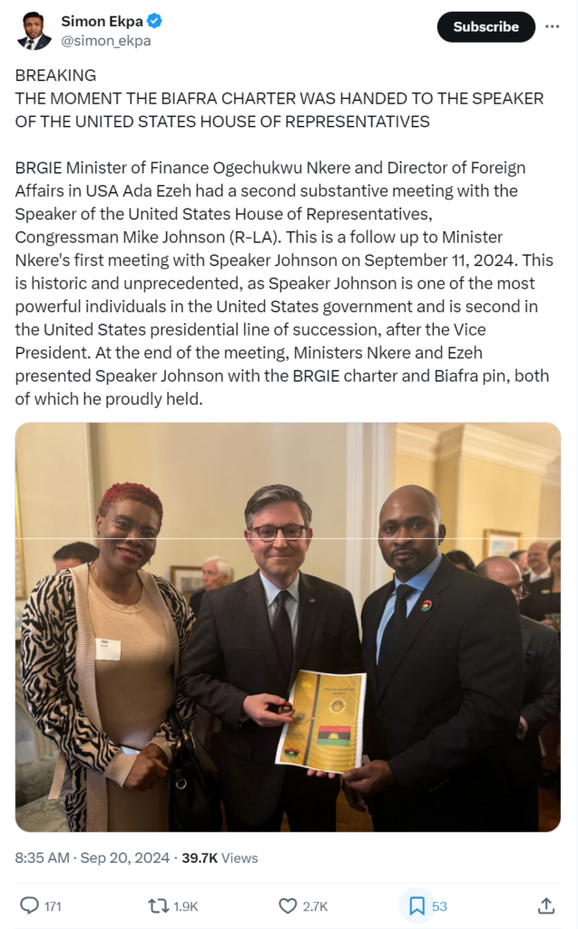 Two individuals standing with a man holding a certificate and pin, caption describes handing over of Biafra Charter to US House Speaker.