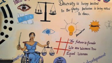 Wall mural with symbols of diversity, inclusion, and female empowerment, including Justice Lady in a wheelchair.