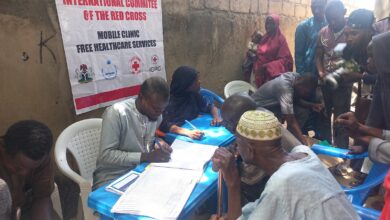 People registering at an ICRC mobile clinic for free healthcare services.