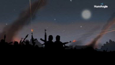 Silhouettes of people with guns against a twilight sky with traces of light and a watermark 'HumAngle'.