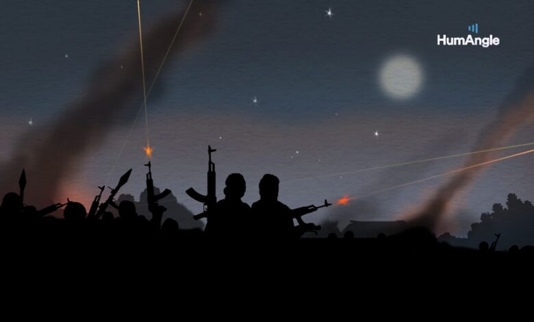 Silhouettes of people with guns against a twilight sky with traces of light and a watermark 'HumAngle'.