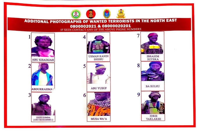 A poster with photographs and names of nine wanted terrorists, contact information provided at the top.