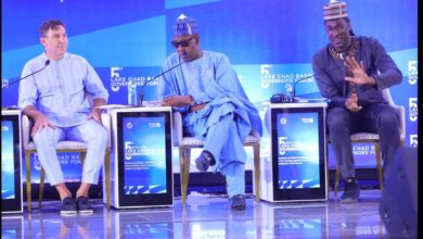 Three men on stage at the 5th Lake Chad Basin Governors' Forum, with blue-themed backgrounds and event branding.