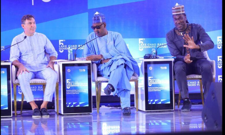 Three men on stage at the 5th Lake Chad Basin Governors' Forum, with blue-themed backgrounds and event branding.