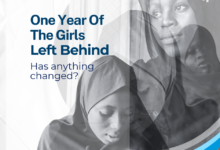 Black and white image of girls in hijabs with text: "One Year Of The Girls Left Behind. Has anything changed?" #BirninYauriGirls