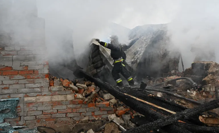 Firefighter amidst smoke, navigating through the debris of a damaged building.