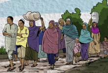 A diverse group of people, including children, walk along a path carrying bundles, with trees in the background.