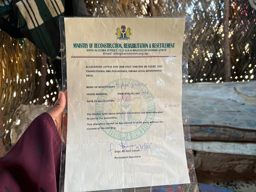 Person holding a government-issued allocation letter for a shelter in Damboa, Borno State, Nigeria, dated 17-08-2023.