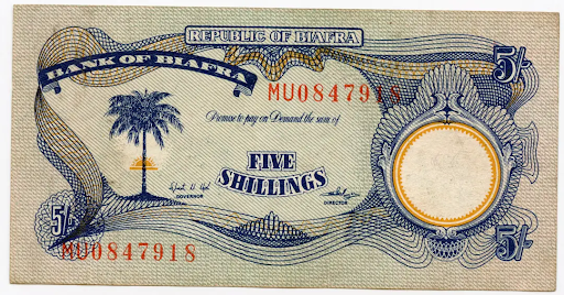 Biafran five shillings note with palm tree, intricate blue patterns, and serial number MU0847918 on textured background.