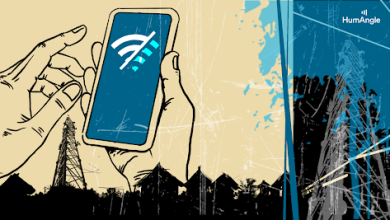 Hands holding a smartphone with a weak signal icon, against a backdrop of communication towers and silhouetted buildings.