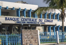 Exterior of Banque Centrale du Congo, Goma branch, with blue accents and a palm tree.