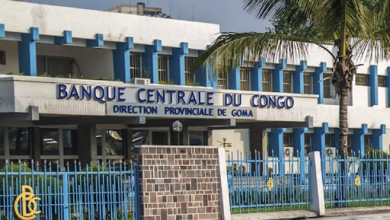 Exterior of Banque Centrale du Congo, Goma branch, with blue accents and a palm tree.