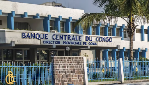Exterior of Banque Centrale du Congo, Goma branch, with blue accents and a palm tree.