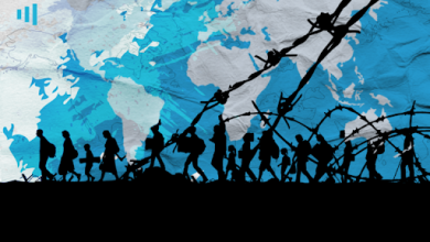 Silhouettes of people walking past barbed wire against a background map, symbolizing migration or refugees.