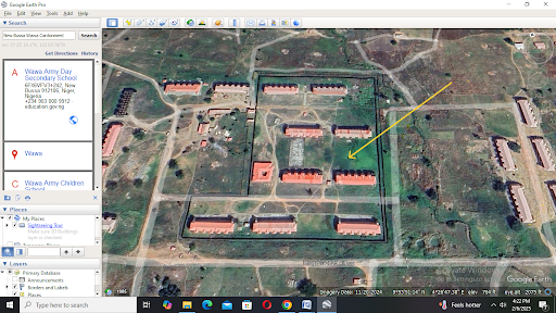 Satellite view of a compound with multiple buildings, highlighted area, and location details displayed on the left.