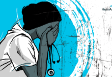 Worried healthcare worker with stethoscope covering face in distress against a blue background.