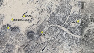 Satellite view of Tamanrasset, Algeria, showing labeled mines and a mining complex in the surrounding desert area.