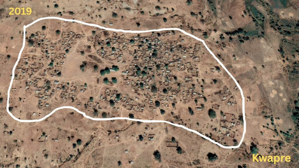 Aerial view of Kwabre in 2019, showing a cluster of buildings and paths within a white boundary on a dry landscape.