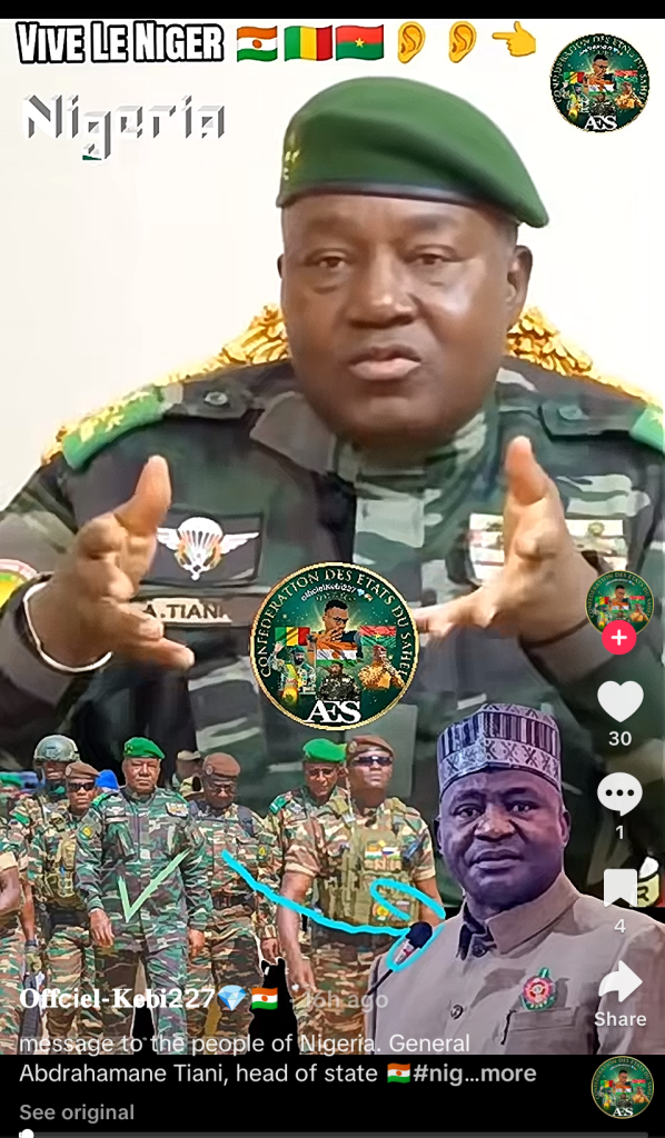 Military officer in uniform speaking, with flags and a group of soldiers in the background; text reads "Vive Le Niger" and "Nigeria".