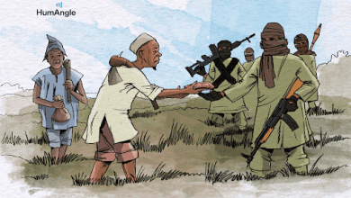 A group of civilians interacts with armed individuals in a field under a cloudy sky.