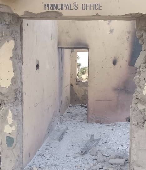 The image shows a dilapidated "Principal's Office" with crumbling walls and debris on the floor.